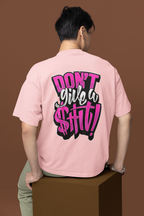 Person wearing a pink t-shirt with a graphic design on the back against a brown background